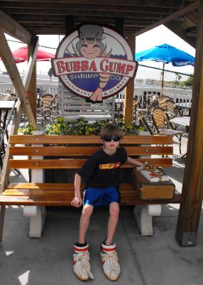 Kyle does the Forest Gump pose at Bubba Gump's