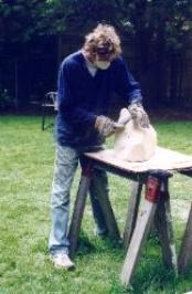 Dennis works a piece of soapstone outdoors at Happy Rock Studio